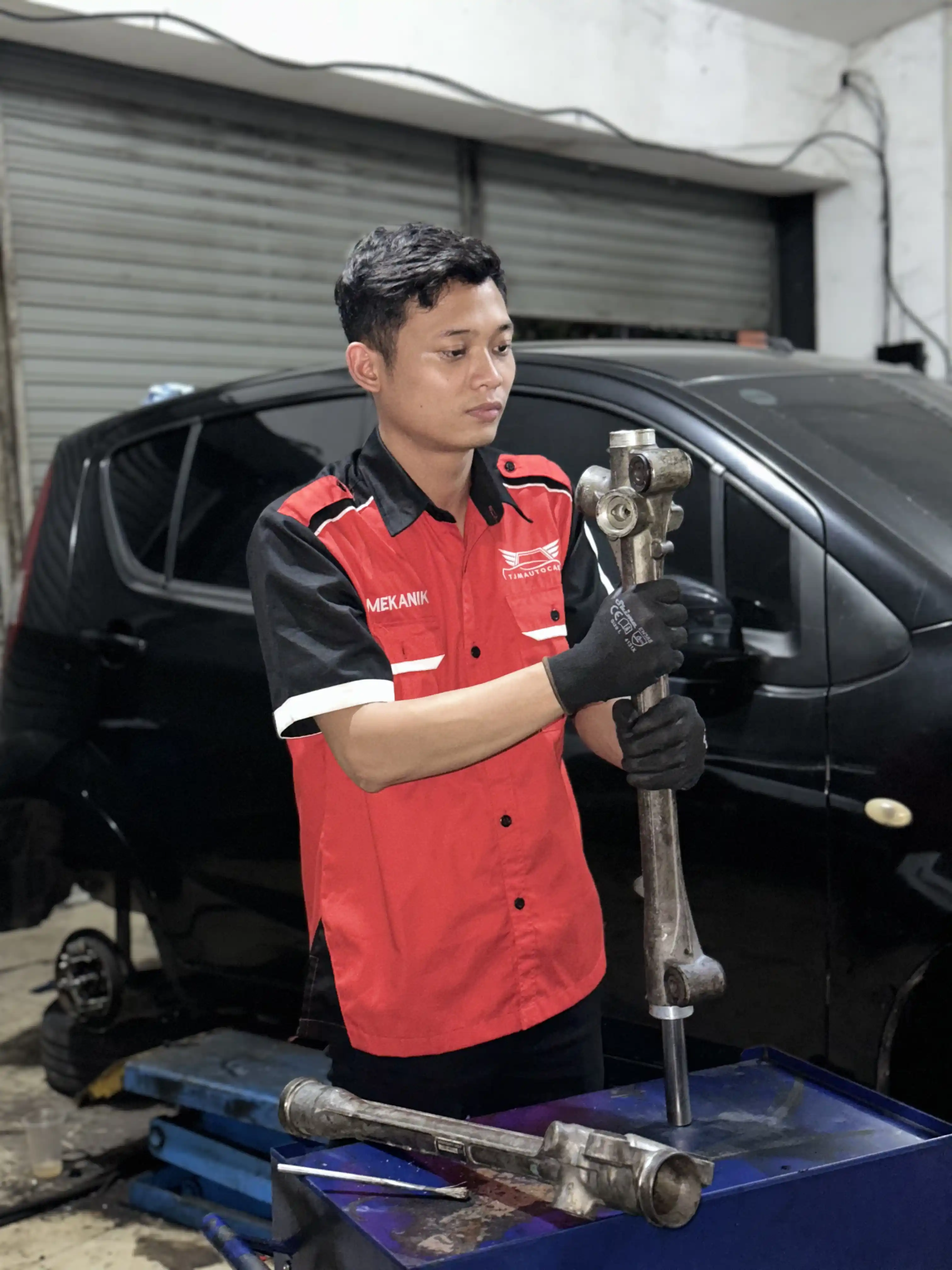 Mekanik memegang komponen rack steer